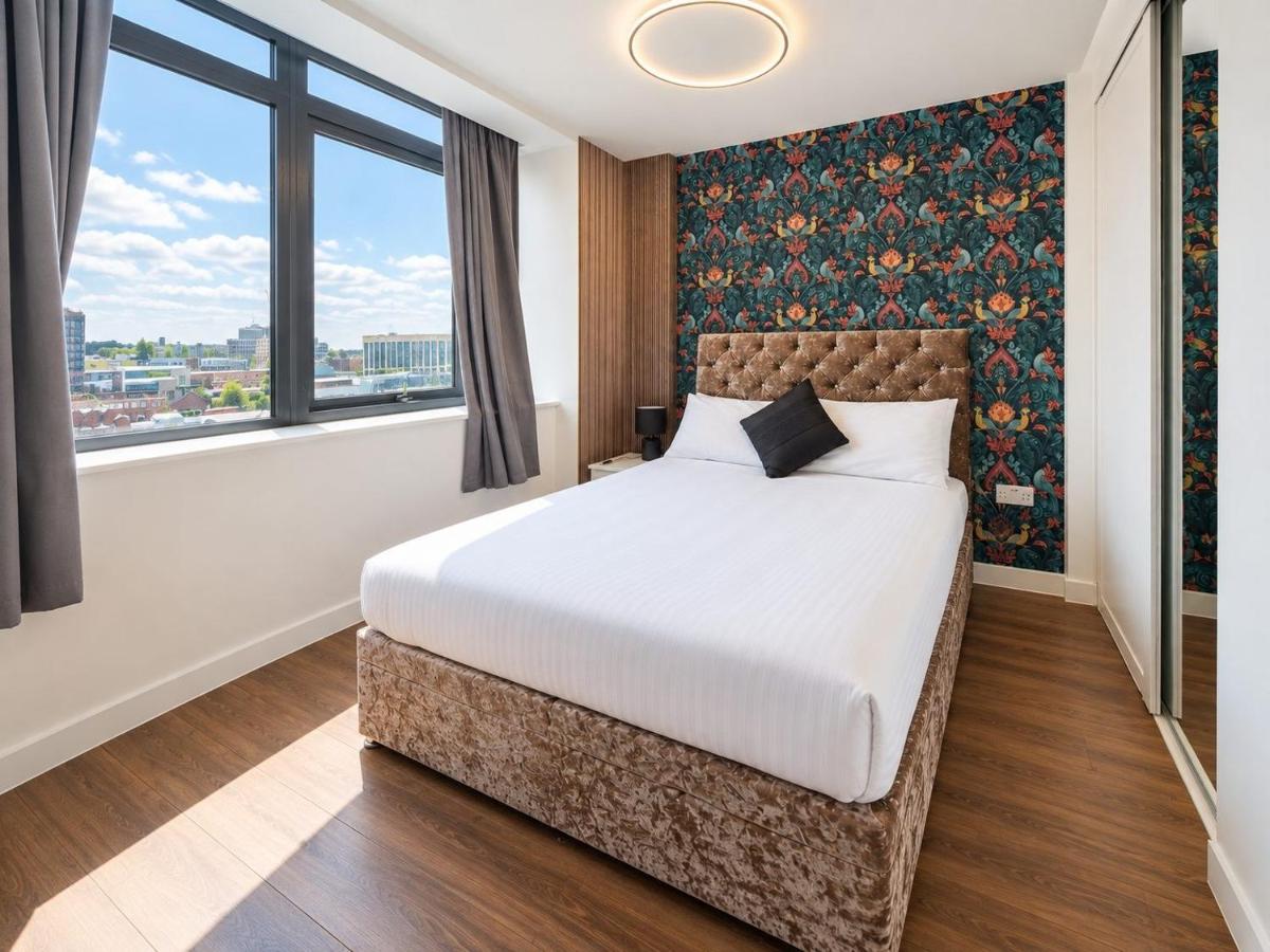a bedroom with a bed and a large window at Sidemersey Livings - 2 Bedroom Central Skyline Apartment with views and parking in Liverpool